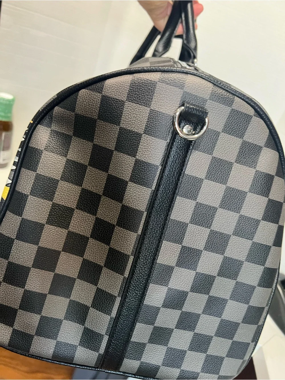Ed Hardy duffel bag features a black and grey checkered pattern
